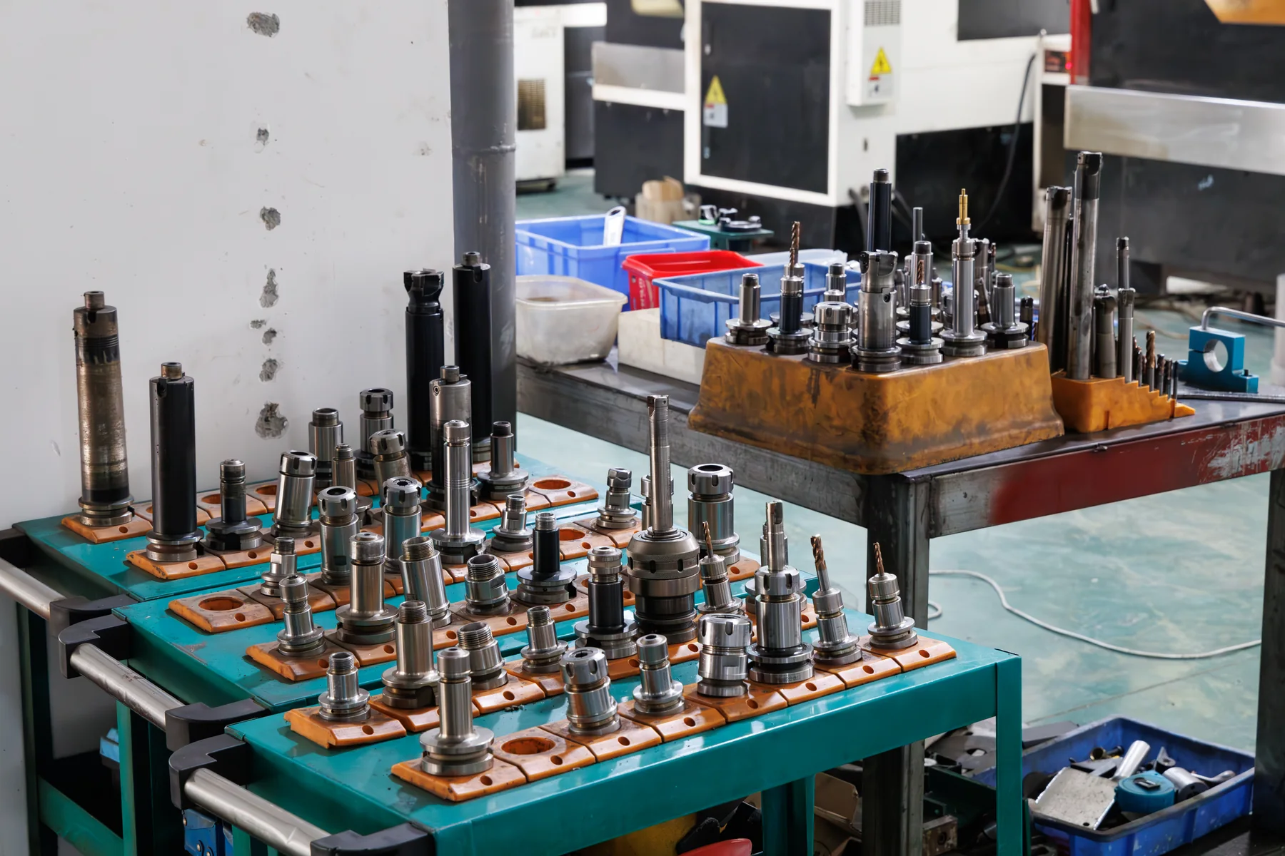 Tool holders and machining tools arranged beside factory equipment