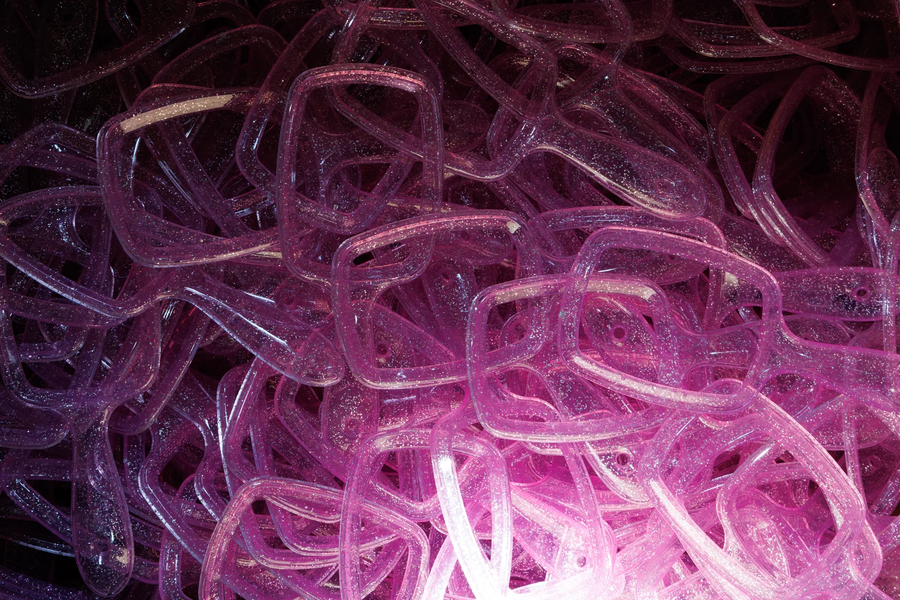 Pink molded brush bodies photographed at the factory