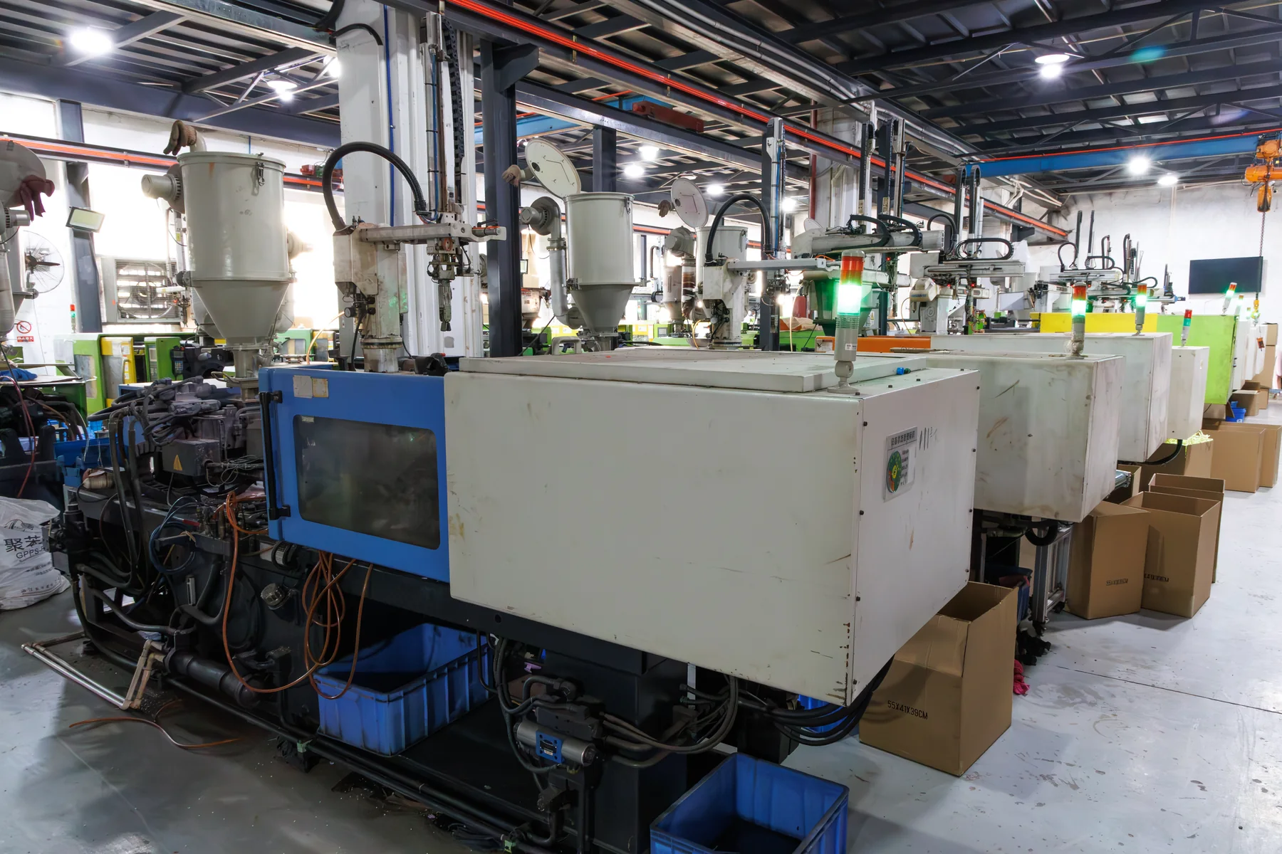 Rows of injection molding machines and material hoppers in the BOFEI workshop